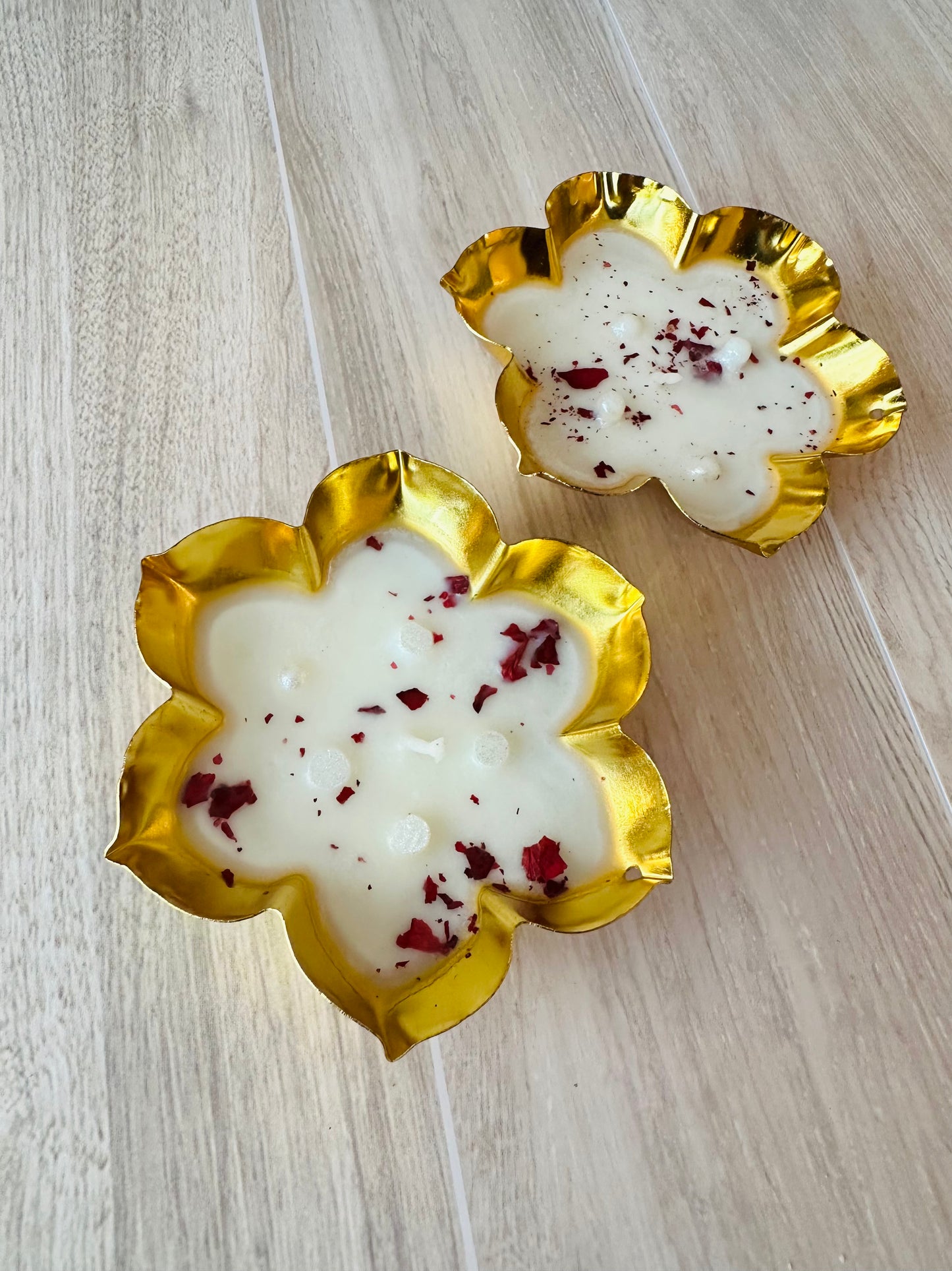 Two decorative urlis  with gold rims and white soy wax 